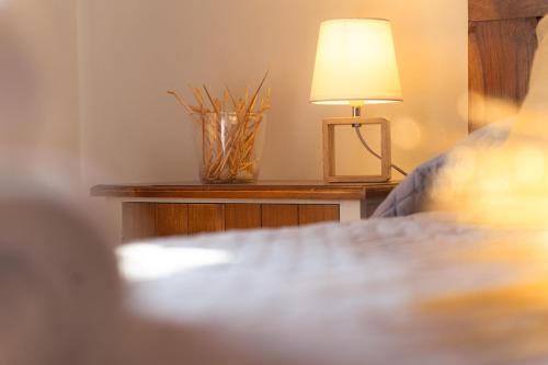 a lamp on a table next to a bed at Cal Massana in Sant Guim de la Plana