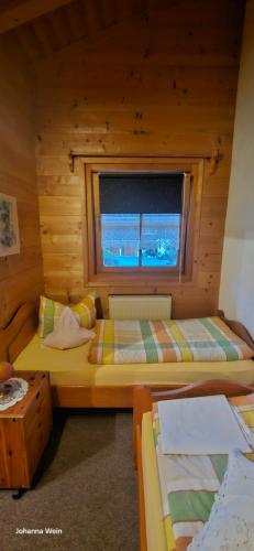 a bedroom with two beds and a window at Ferienwohnung Wein in Berchtesgaden