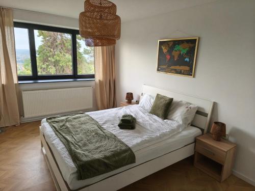 a bedroom with a bed and a large window at Gödöllő Country Home in Gödöllő