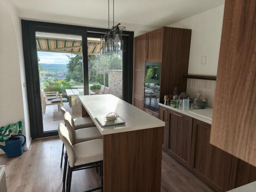 a kitchen with a counter and a view of a patio at Gödöllő Country Home in Gödöllő