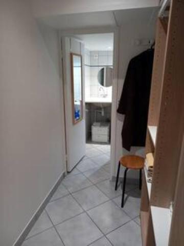 a room with a hallway with a door and a chair at Jasmin in Le Vésinet