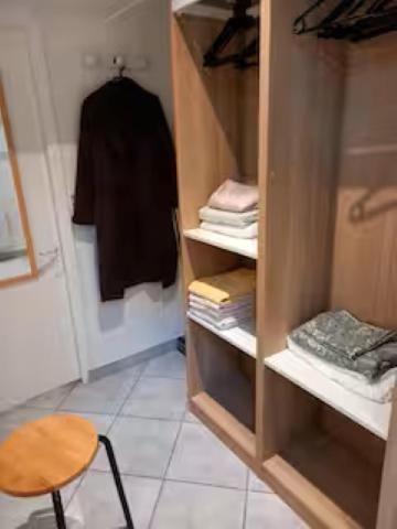 a walk in closet with a table and a chair at Jasmin in Le Vésinet