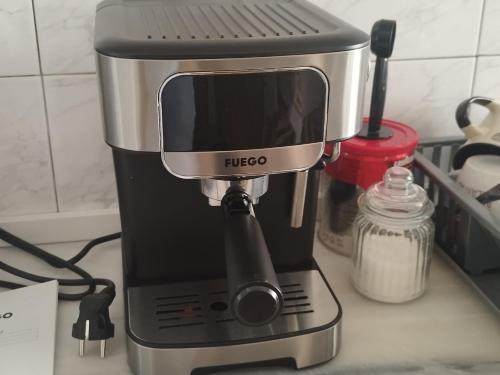 a black and silver coffee maker sitting on a counter at The Guest Apartament 2 bedrooms Fier in Fier