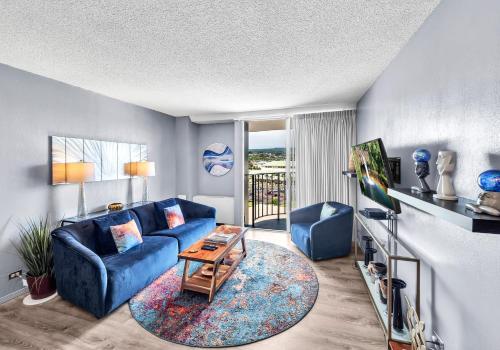a living room with a blue couch and a table at Hilo Lagoon Center #911 in Hilo