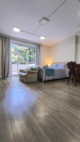 a large living room with a bed and a couch at Saint Sebastian 106 in Jaraguá do Sul