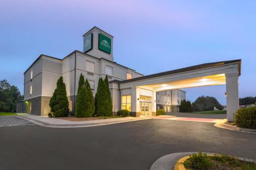 a large white building with a clock tower on top at Wingate by Wyndham Dublin Near Claytor Lake State Park in Dublin