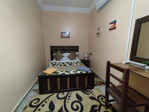 a bedroom with a bed and a mirror at Sahara Dream Apartment in Merzouga
