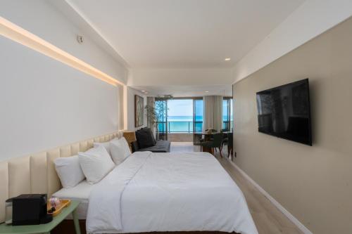 a hotel room with a bed and a television at Urban - Beira Mar Boa Viagem in Recife