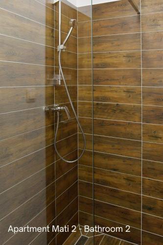 a shower with a hose on a wooden wall at Amálkin Dvor in Podbrezová