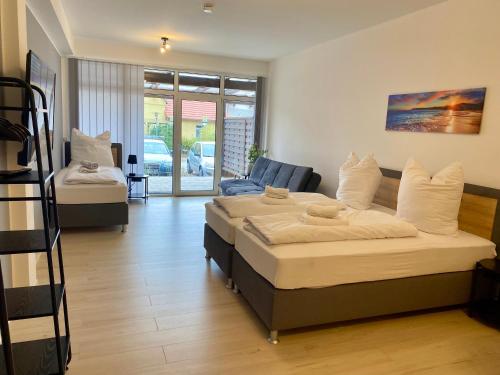 a living room with two beds and a staircase at Klein und fein - Terrasse - Stellplatz - WIFI - Star Park 