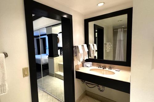a bathroom with a sink and a mirror at OYO Hotel and Casino Las Vegas in Las Vegas