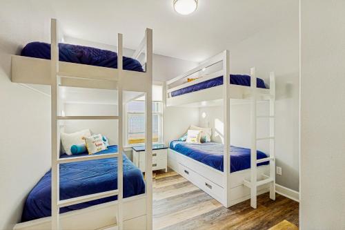 a bedroom with two bunk beds and a mirror at Haven Gulf Views Cargo Lift Large Deck in Crystal Beach