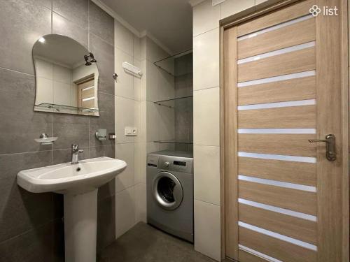 a bathroom with a sink and a washing machine at Apartment Zaqyan street in Yerevan