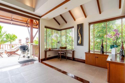 a living room with large windows and a camera at Patong Seaview Luxury Villa Penda in Patong Beach