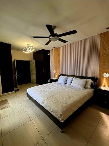 a bedroom with a bed with a ceiling fan at Habitacion Olmo in Saltillo