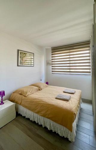 a bedroom with a large bed with two towels on it at Charmant appartement plein centre in Saint-Tropez
