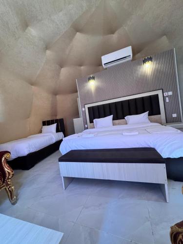 a large bedroom with two beds in a room at Wadi Rum Marcanã camp in Aqaba