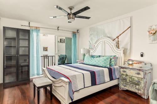 a bedroom with a bed and a ceiling fan at Beach Front Bungalow At Pacific Beach in San Diego