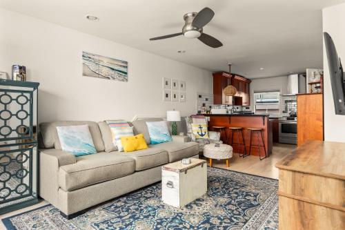 a living room with a couch and a kitchen at Beach Front Bungalow at Pacific Beach in San Diego