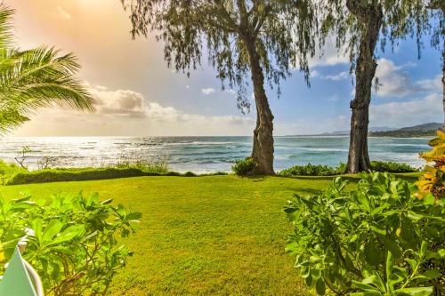 a lawn with trees and the ocean in the background at Kapa'a Sands 13 in Kapaa