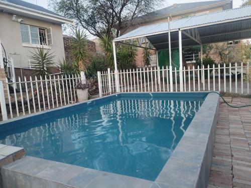 a swimming pool in front of a house at Uitzight - Pool unit in Beaufort West