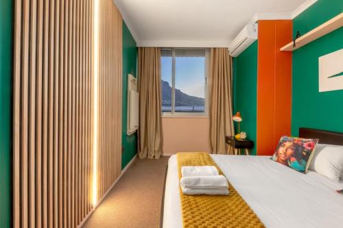 a bedroom with a large bed and a window at Emerald Escape With Mountain View & Pool in Cape Town