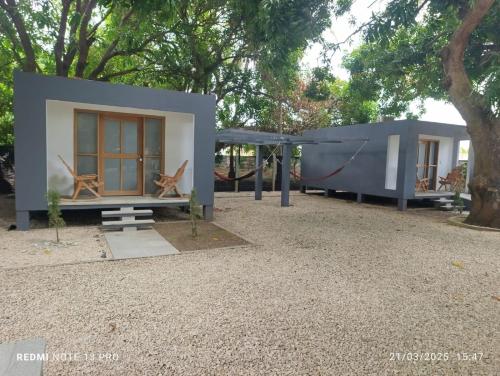 a tiny house with a hammock and a swing at Mango Beach in San Bernardo del Viento