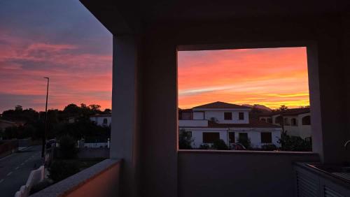 a view of a sunset from a window of a house at Oltre le Dune in Murta Maria