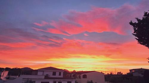 a sunset with a colorful sky with clouds at Oltre le Dune in Murta Maria