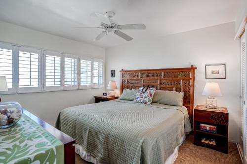 a bedroom with a bed and a ceiling fan at Wailua Bay View 206 in Wailua