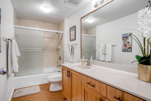 a bathroom with a sink and a toilet and a shower at Wailua Bay View 206 in Wailua
