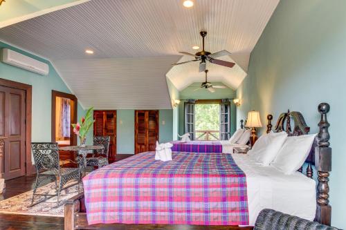 a bedroom with a large bed with a plaid blanket at Monkey Suite at Mahogany Hall -Gold Standard Certified in Bullet Tree Falls