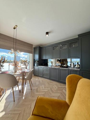 a kitchen and dining room with a table and chairs at Apartament Charlotte 2 in Bolesławiec