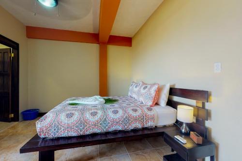 サン・ペドロにあるNew River #7 at Laguna Suite -Gold Standard Certifiedのベッドとランプ付きのテーブルがある寝室