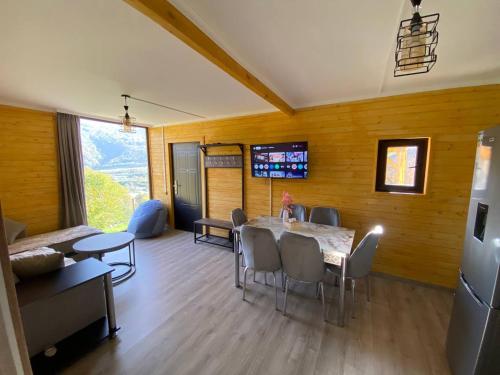 a dining room with a table and chairs in a room at Forest Panorama House Dilijan in Dilijan