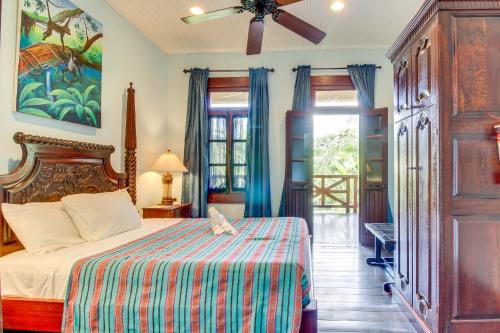 a bedroom with a bed and a ceiling fan at Parrot Room at Mahogany Hall -Gold Standard Certified in Bullet Tree Falls