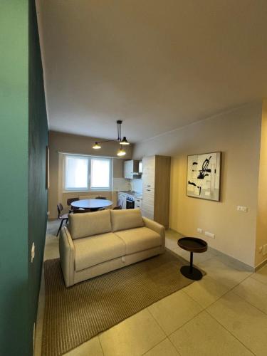 a living room with a couch and a table at L'Atelier - 2 min walk to Bernina Express in Tirano