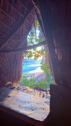 a view of the ocean from a window in a hut at El Chiringuito, Mermejita in Mazunte