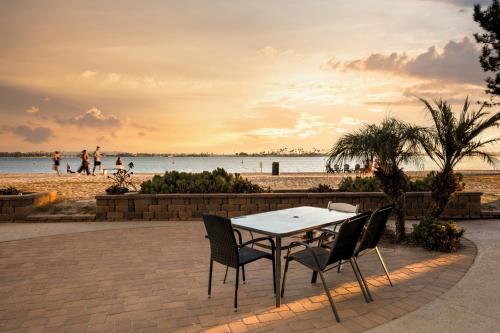 a table and chairs in front of a beach at Beach Front Bungalow at Pacific Beach in San Diego