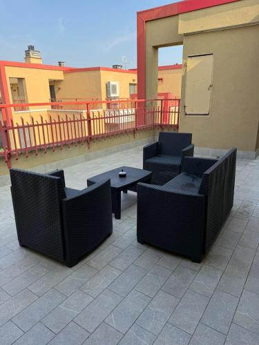 a patio with chairs and tables on a balcony at Milan Penthouse - Humanitas - IEO - La casa di Martina in Pieve Emanuele