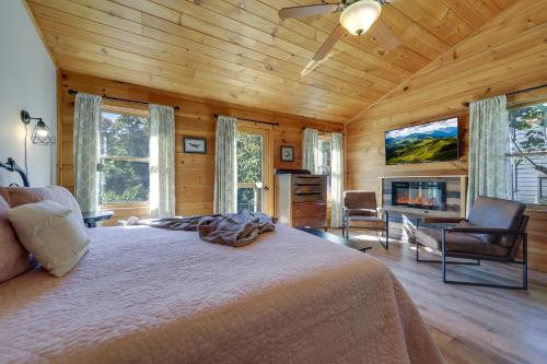 a bedroom with a large bed and a fireplace at Hot Tub and Resort Perks! Gatlinburg Mtn Retreat in Gatlinburg