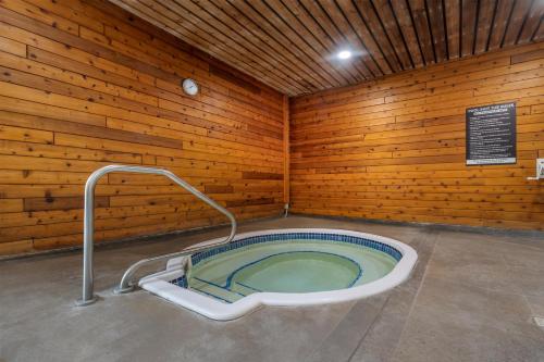 a bath tub in a room with wooden walls at Best Western Sicamous Inn in Sicamous