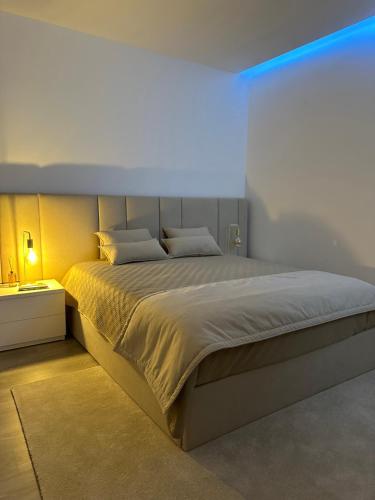 a bedroom with a large bed and a blue light at Quinta da Costa in Monsul