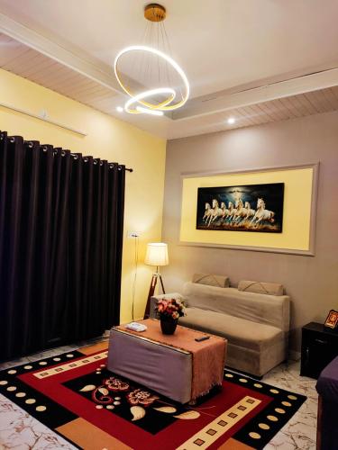 a living room with a couch and a table at Terminal View Homestay in Jabalpur