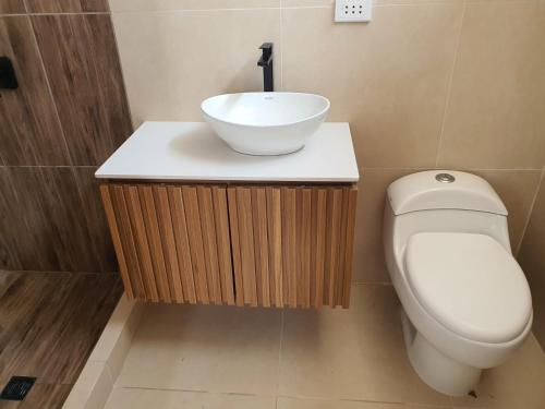 a bathroom with a sink and a toilet at CASA PLAYA con PISCINA in Punta Negra
