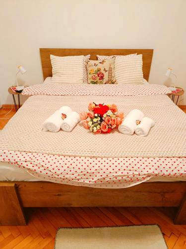a bed with three towels and flowers on it at Home Sweet Home No1 in Belgrade