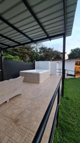a patio with a canopy with a hot tub in a yard at Las Guias Cabaña Privada in Río Hato