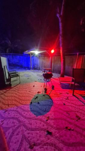 a lit up room with a table and red lights at Las Guias Cabaña Privada in Río Hato
