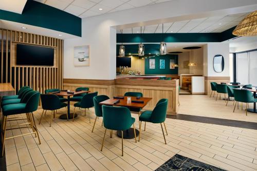 a restaurant with tables and chairs and a bar at The DEXTRO Little Italy, BW Premier Collection in San Diego