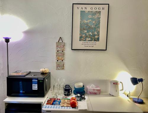 a table with a microwave and a lamp and a picture at Redwood View Suite 326SQFT Private Entrance and Bath in Scotts Valley